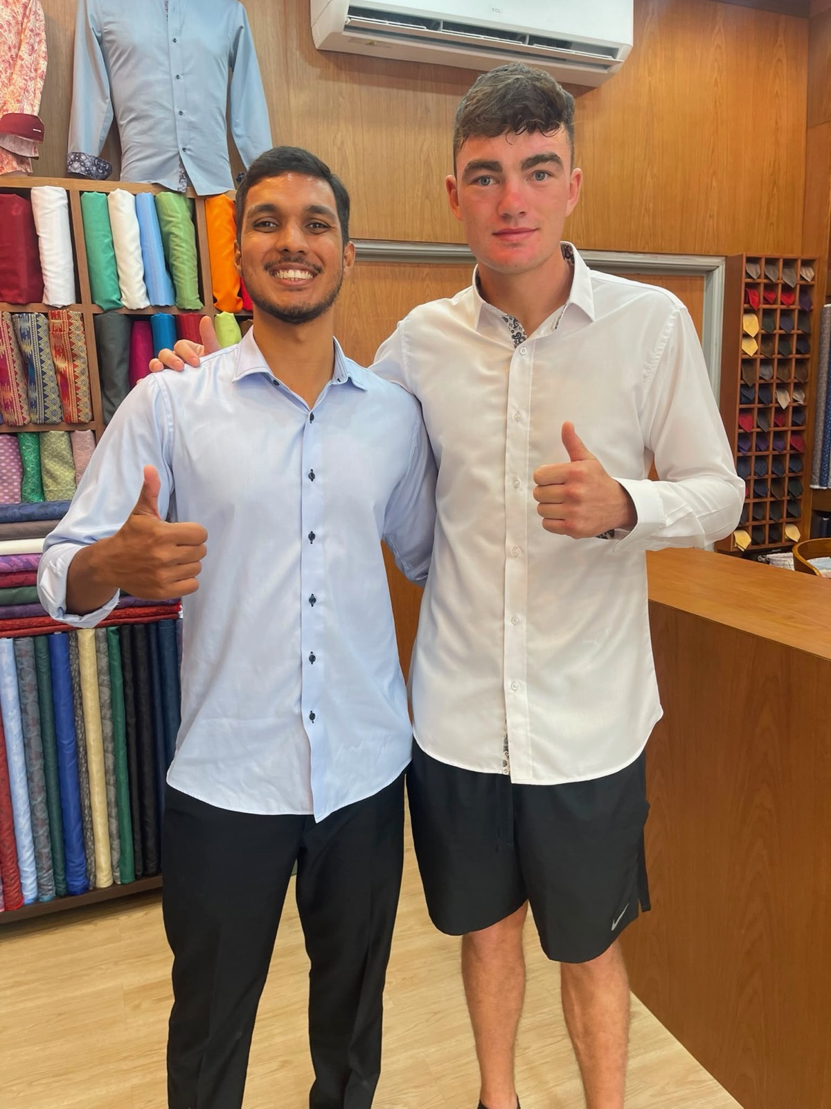Client and tailor giving a thumbs up