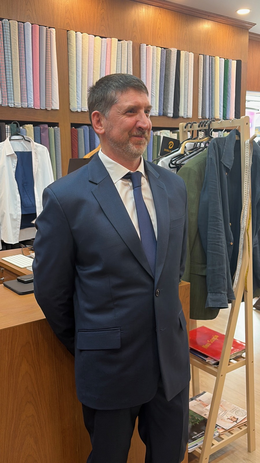 Client in a navy suit with blue tie