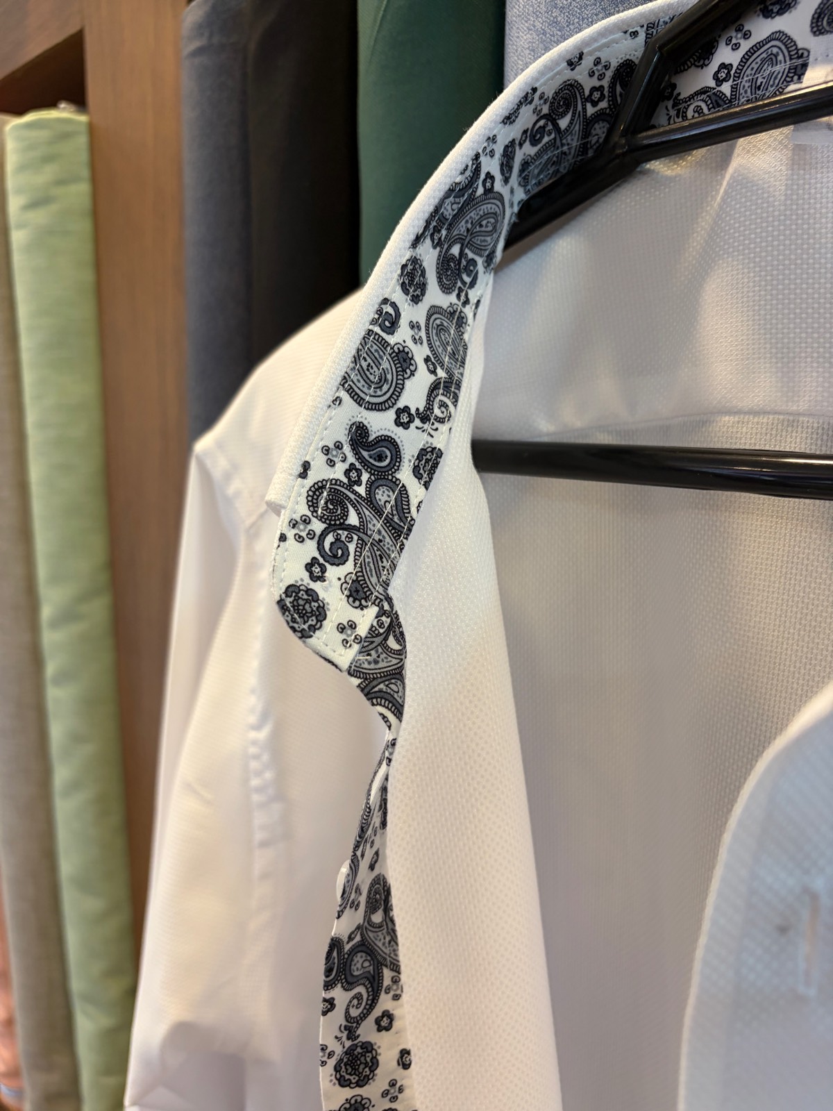 Paisley-trimmed inner collar detail on a white shirt