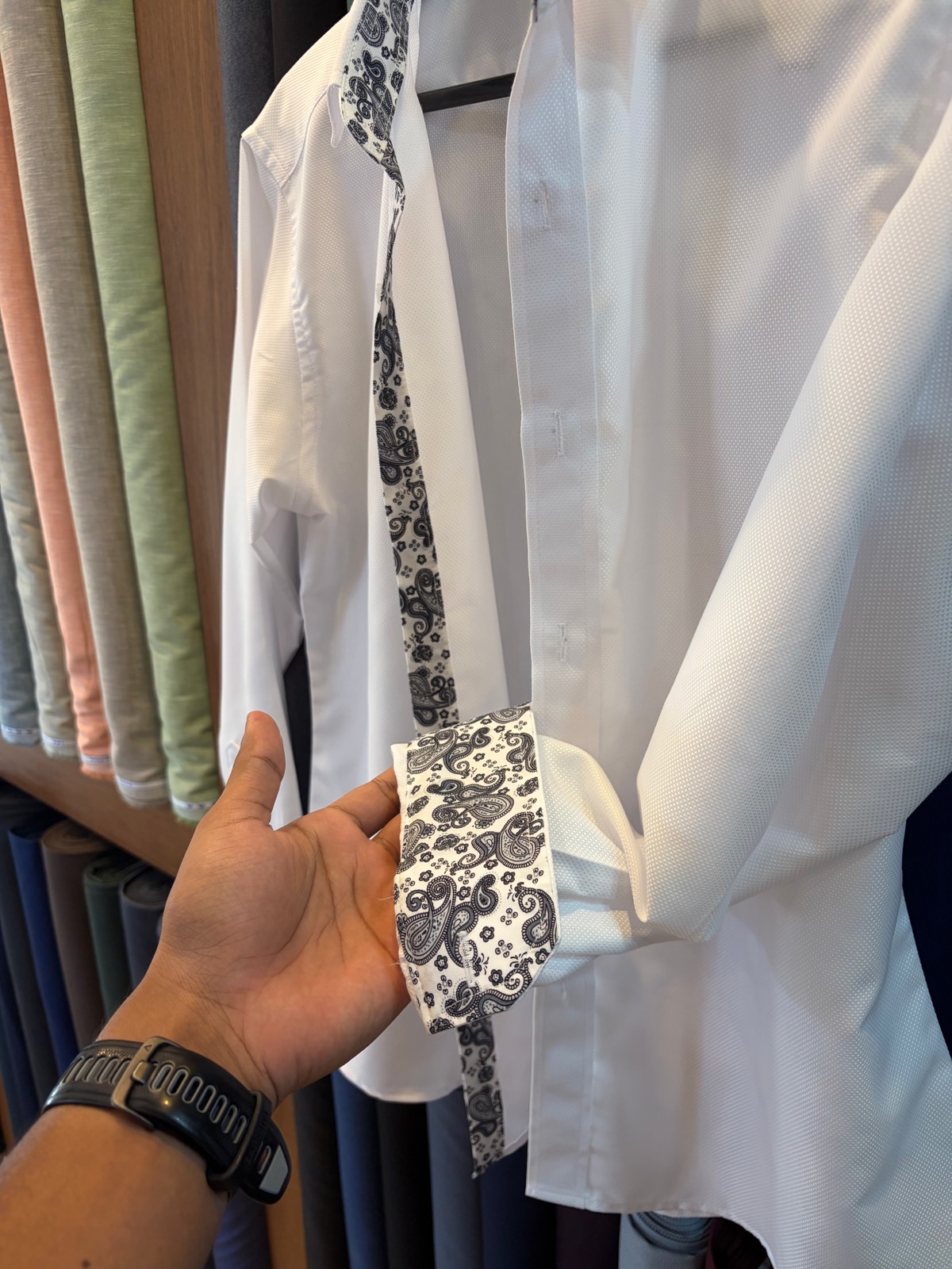 Paisley-trimmed cuff detail on a white shirt
