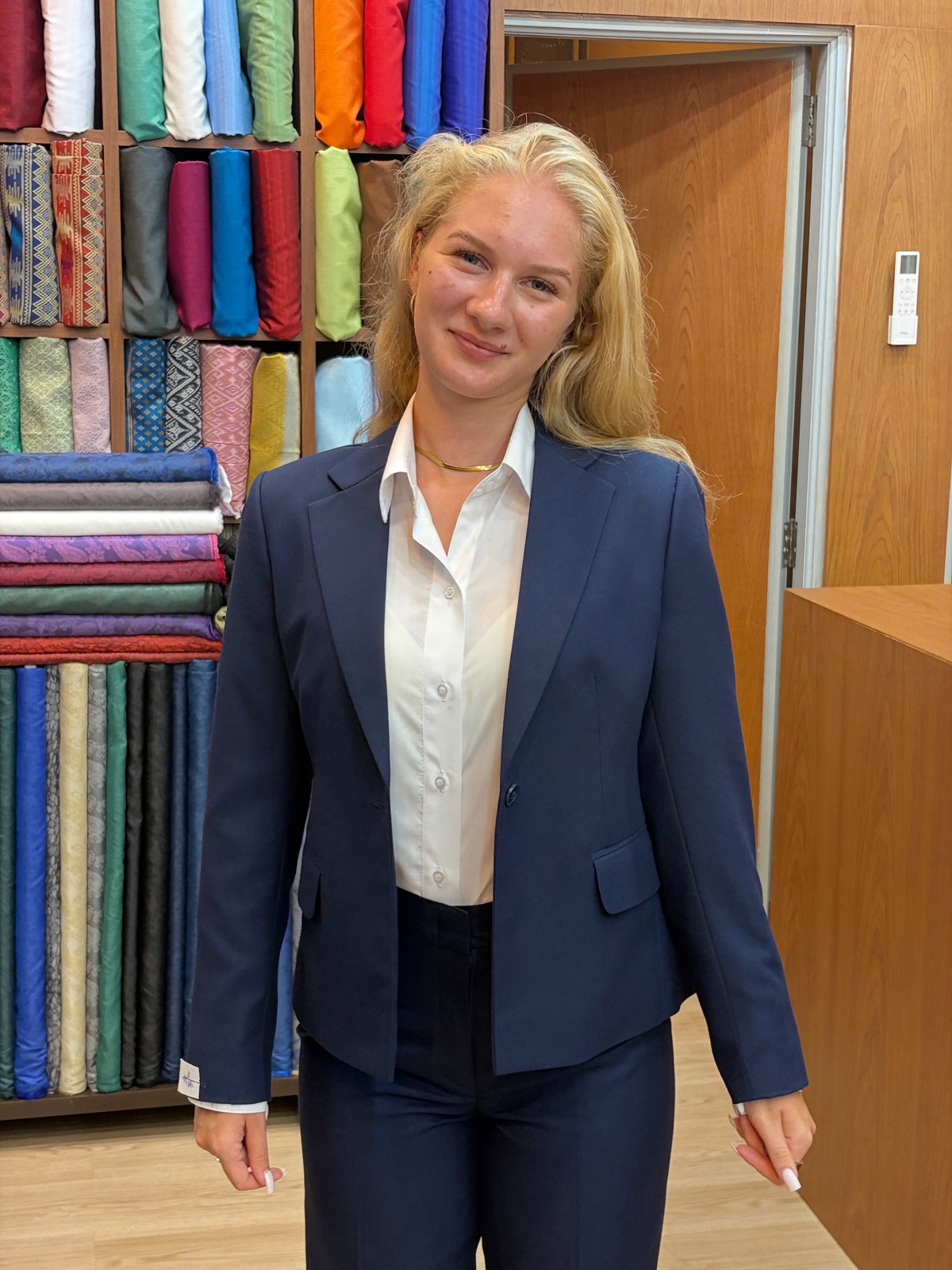 Client in a bespoke women's navy pantsuit